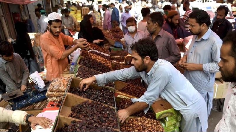 People buy dates at a market ahead of Ramadan during a nationwide lockdown in Karachi. AFP People buy dates at a market ahead of Ramadan during a nationwide lockdown in Karachi. AFP