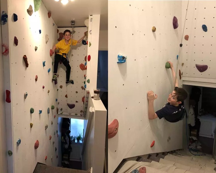 2个小朋友十分喜欢攀岩，在家里也玩得不亦乐乎。