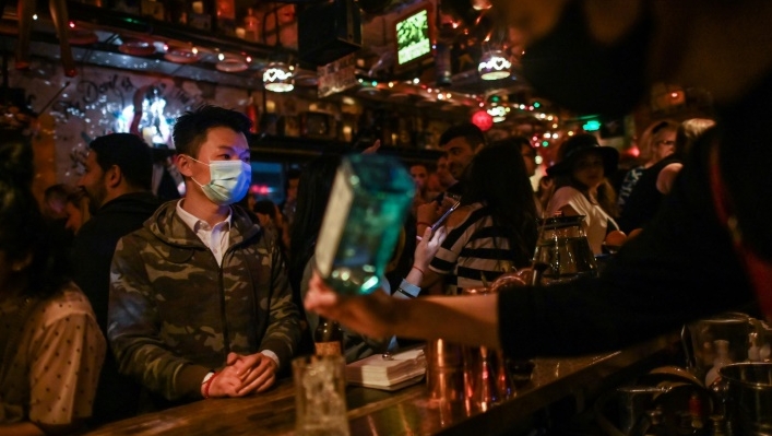 A Shanghai bar patron waits for his drink while wearing a mask. AFP A Shanghai bar patron waits for his drink while wearing a mask. AFP