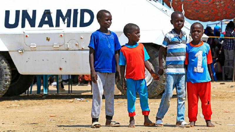 Displaced Sudanese boys pose in front of a UN-African Union mission to Darfur (UNAMID) vehicle. AFP Displaced Sudanese boys pose in front of a UN-African Union mission to Darfur (UNAMID) vehicle. AFP