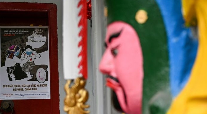 A poster by Tran Duy Truc on preventing the spread of coronavirus outside a Buddhist temple in Hanoi. AFP A poster by Tran Duy Truc on preventing the spread of coronavirus outside a Buddhist temple in Hanoi. AFP