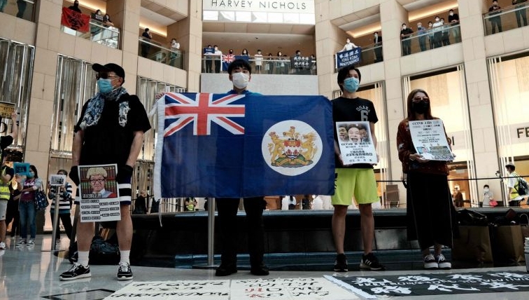 Pro-democracy protesters observe social distancing as they gather at a shopping mall in Hong Kong. AFP Pro-democracy protesters observe social distancing as they gather at a shopping mall in Hong Kong. AFP