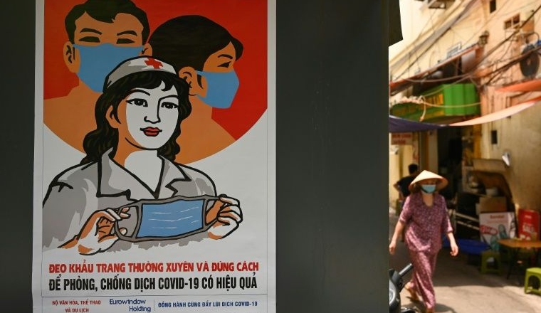 A poster in the style of Vietnamese communist propaganda art warns against the spread of coronavirus in Hanoi. AFP A poster in the style of Vietnamese communist propaganda art warns against the spread of coronavirus in Hanoi. AFP