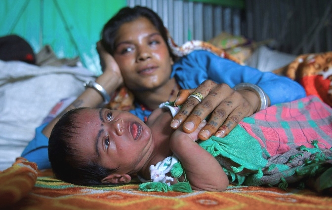 Manju Bauri rests with her newborn baby boy 'Lockdown' in their temporary home in northeast India. AFP Manju Bauri rests with her newborn baby boy 'Lockdown' in their temporary home in northeast India. AFP