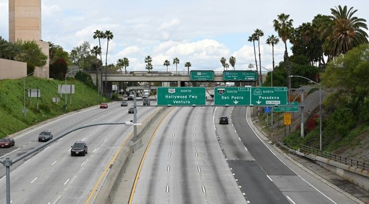 The pandemic has muted the call of the open road for vacationers, and this Los Angeles highway is seen nearly empty in April. AFP The pandemic has muted the call of the open road for vacationers, and this Los Angeles highway is seen nearly empty in April. AFP
