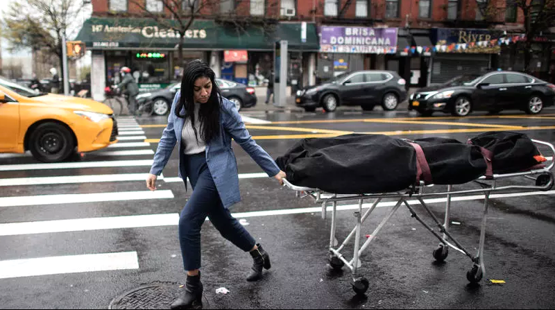Alisha Narvaez of International Funeral & Cremation Services transports a body in New York's Harlem neighborhood. AFP Alisha Narvaez of International Funeral & Cremation Services transports a body in New York's Harlem neighborhood. AFP