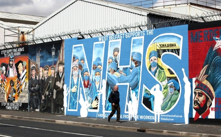 Street art in Belfast now lauds health service workers in the frontline. AFP 