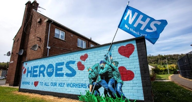 Street art paying tribute to the NHS mimics the epic flag raising by US marines on the Japanese island of Iwo Jima in World War II. AFP
