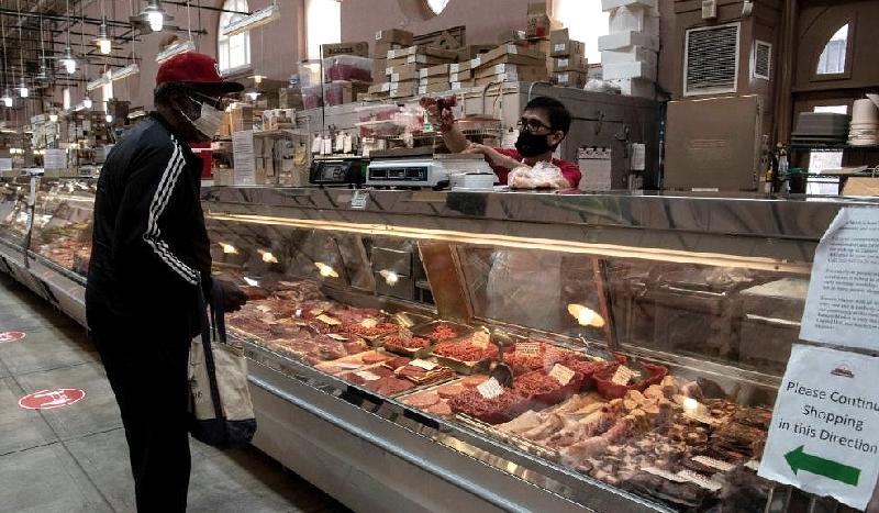 A man purchases meat at in Washington, DC. AFP