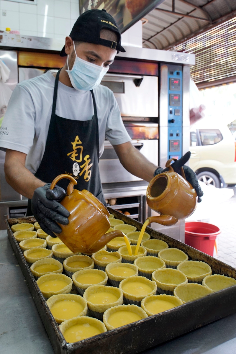 南香茶餐室员工把蛋浆注满蛋挞内，未进入烤炉，卖相已令人垂涎欲滴。