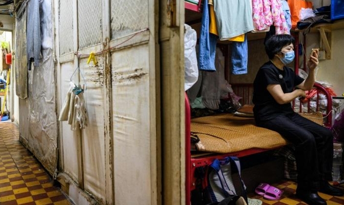 As well as the one Wong shares with her son, five other 'cubicles' have been squeezed into an apartment meant for a single family. AFP