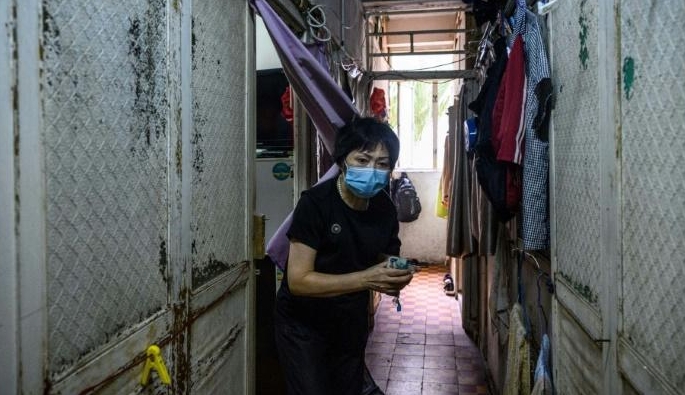Wong Mei-ying knows social-distancing is almost impossible in the Hong Kong flat she shares with 12 other people. AFP