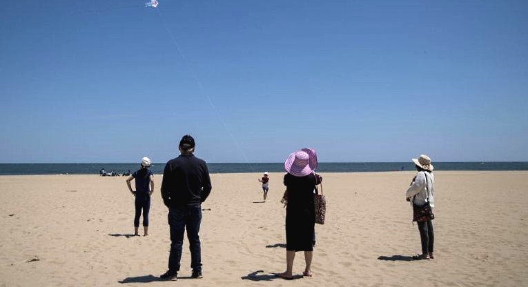 People are seen on the beach as the area reopens in Ocean City, Maryland. AFP People are seen on the beach as the area reopens in Ocean City, Maryland. AFP