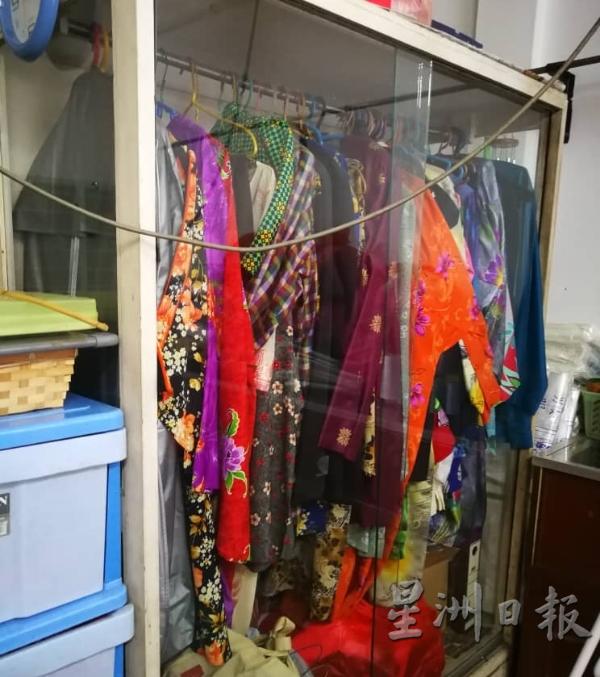 陈年开斋节未领服装，李氏收藏在玻璃橱柜中。（图：星洲日报）