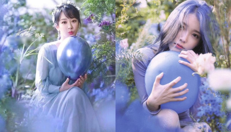 两人抱着一个蓝色的大气球，虽然IU（右）抱着的是磨砂面，而杨紫（左）抱着的是亮面的，但整个画面里的元素、色调、造型都十分相似。