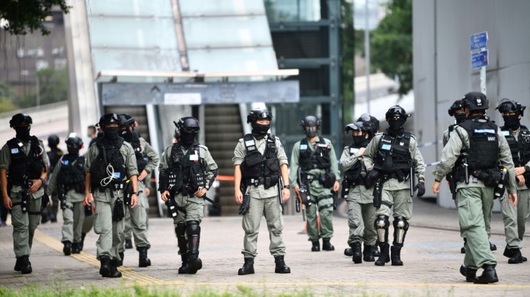 Hong Kong police clamp down on national anthem law protestors. AFP