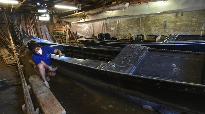 Elisabetta Tramontin sands a gondola at the historic Tramontin shipyard. AFP