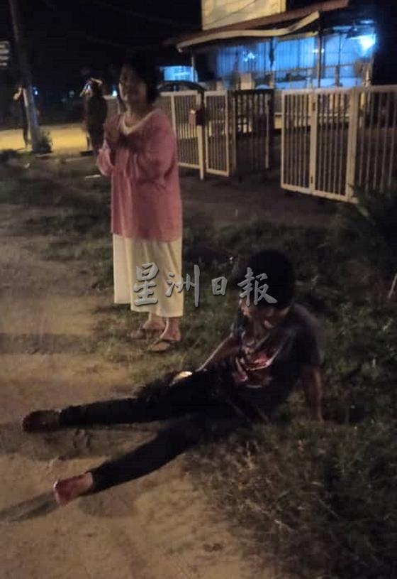 伤者在路边等待被送往医院。