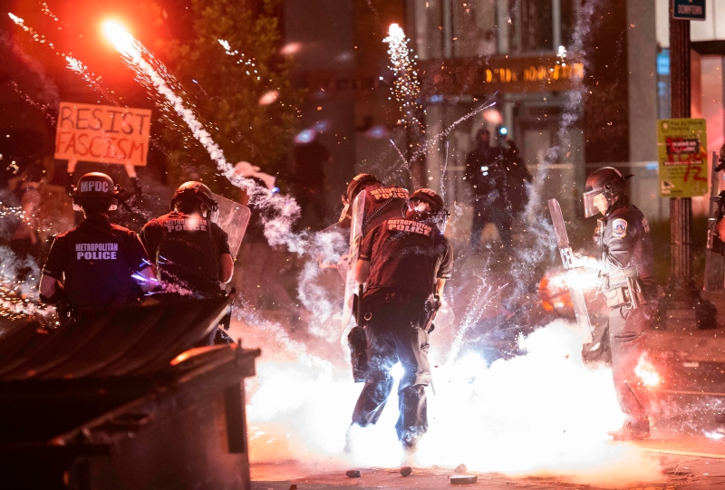 在华盛顿特区警民对峙期间，有示威者朝防暴警丢掷爆竹。
