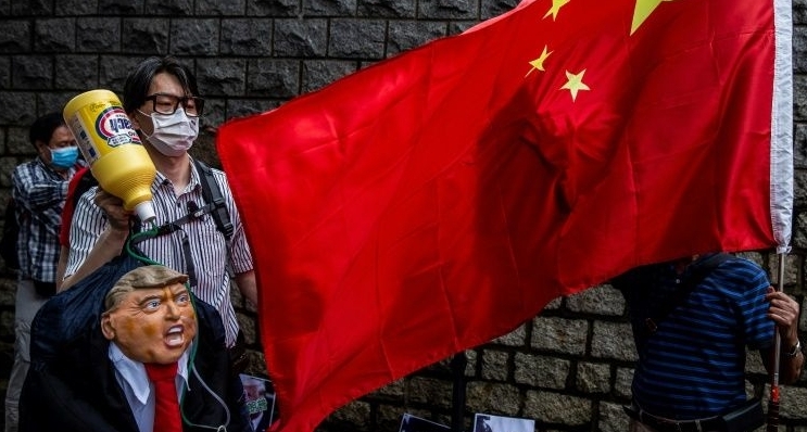 A pro-China protester holds an effigy of Donald Trump outside the US consulate in Hong Kong. AFP