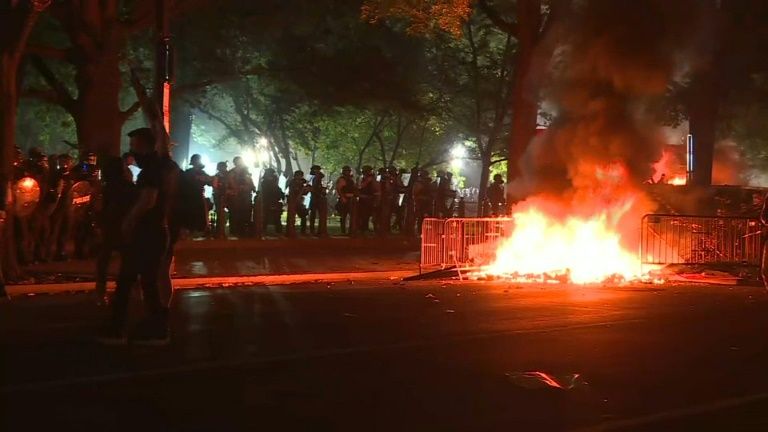 Protesters light fires near the White House. AFP