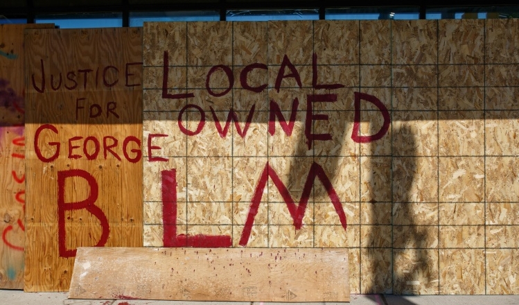 Business owners have boarded up their shops with panels that read 