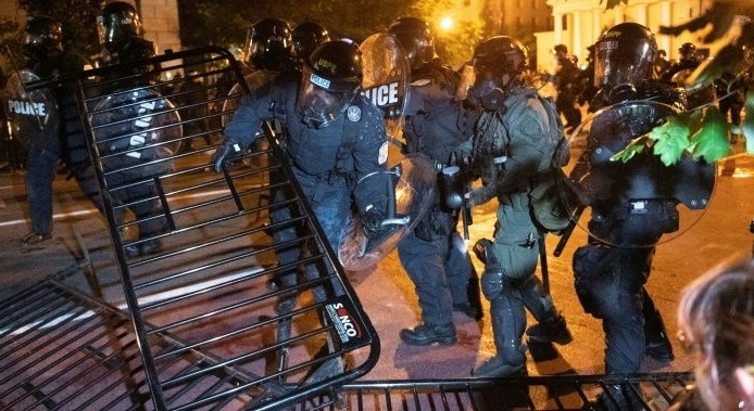 Police charge a barricade in the street during a demonstration near the White House. AFP