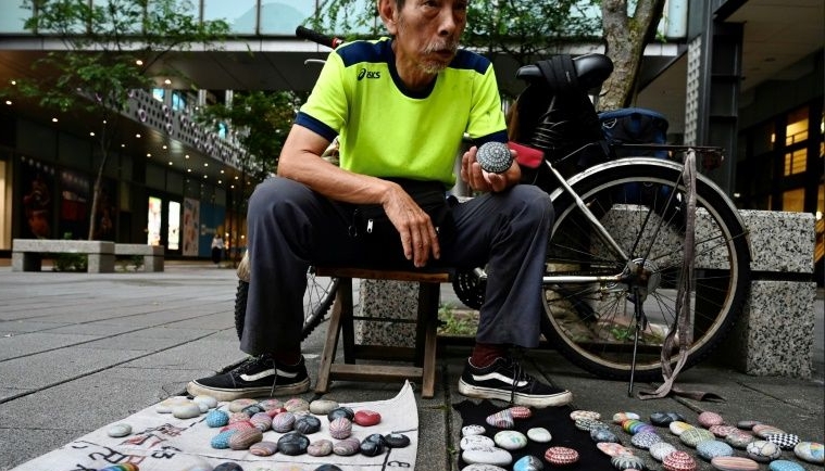 Artist Wu Rong-bi has been dubbed 'Uncle Stone' by his fans after the small pebbles he intricately paints. AFP