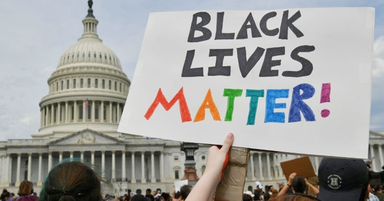 A protestor holds up a sign near the US Capitol in Washington, DC. AFP