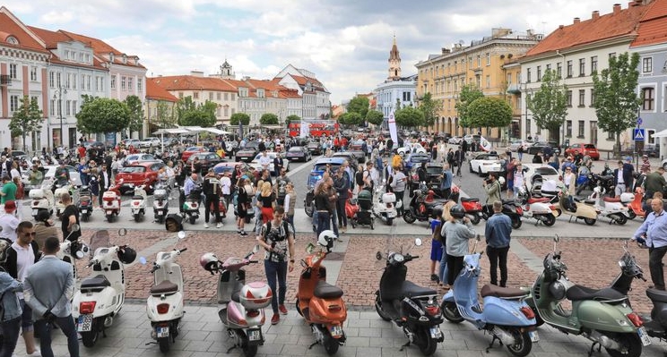 Visitors check out the legendary Italian Vespa scooters and Alfa Romeo cars at Town Hall Square. AFP