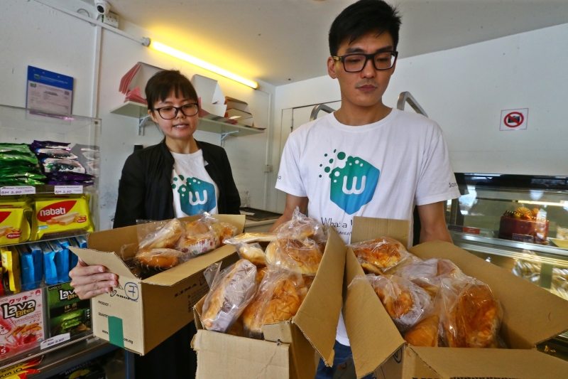 陈美仪（左起）和曾彦哲接获SS19区一家面包店要捐赠面包的通知，采访当天两人共拯救了59个面包，足以能够喂饱59人的肚子。