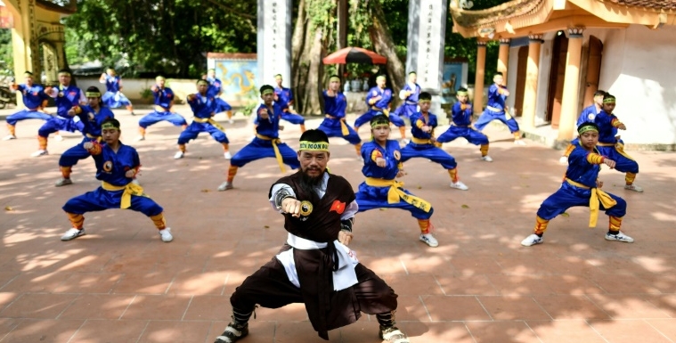 Master Nguyen Khac Phan (front) leads students through a training class in centuries-old martial art Thien Mon Dao inside the Bach Linh temple compound at Du Xa Thuong village in Hanoi. AFP