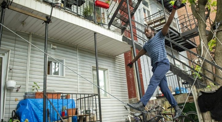 Antino Pansa installed a slack wire between two trees at his apartment in Montreal, so that he could continue practicing his circus skills. AFP