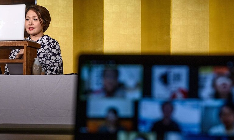 Chacha sits on her knees with her fingertips neatly placed on the wooden floor, gracefully bowing to an audience watching online. AFP