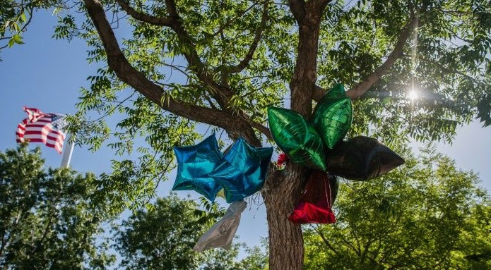 Balloons hang from a tree as a makeshift memorial for Robert Fuller, with the US flag in the background at Palmdale City Hall. AFP Balloons hang from a tree as a makeshift memorial for Robert Fuller, with the US flag in the background at Palmdale City Hall. AFP