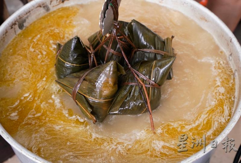 大粒的粽子要熬煮8小时才能出炉，锅盖一打开就散发浓郁的粽香，色泽油亮的粽子让人垂涎。