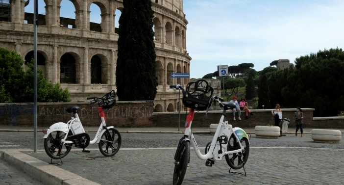 Helbiz electric bikes outside the Colosseum in Rome. AFP