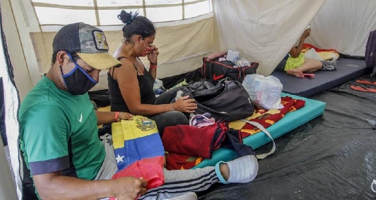 Venezuelan migrants sit inside tents set up at Tienditas International Bridge in Cucuta, Colombia, waiting to return to their country amid the pandemic. AFP