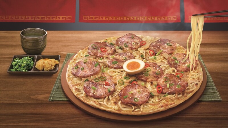 台湾披萨业者“必胜客”与日本冠军拉面店“面屋武藏”合作推出全球首创的“一口入魂拉面”披萨。