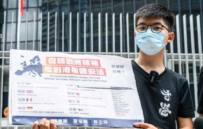 Prominent democracy campaigner Joshua Wong tweeted: 'It marks the end of Hong Kong that the world knew before. With sweeping powers and ill-defined law, the city will turn into a #secretpolicestate.' AFP
