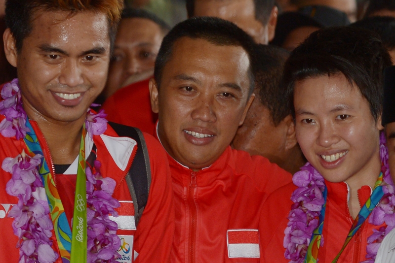 图为伊曼（中）于2016年在雅加达苏卡诺─哈达国际机场与夺得里约奥运金牌返抵国门的印尼羽球混双组合旦都威（左）和莉莉雅娜合照。（法新社照片）