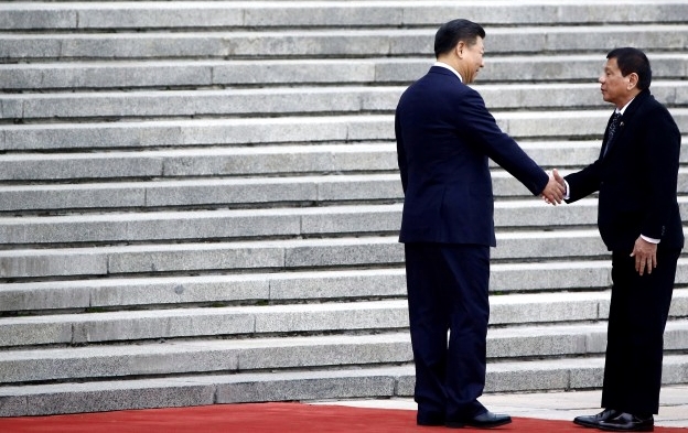 2016 file photo showing Philippine President Rodrigo Duterte and Chinese President Xi Jinping shake hands during a welcoming ceremony at the Great Hall of the People in Beijing. REUTERS