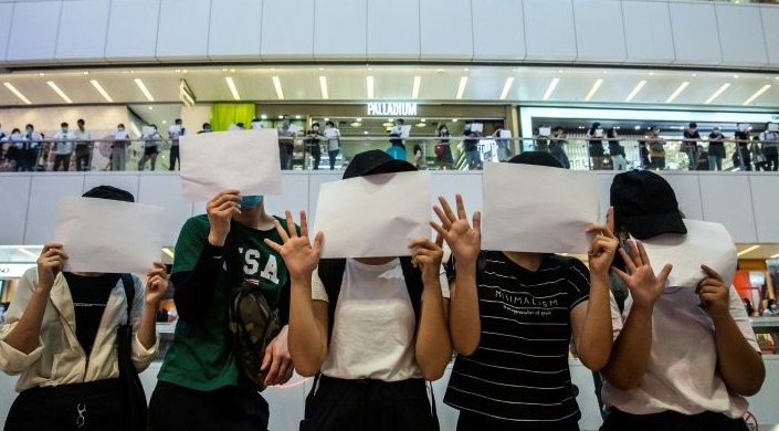Protesters hold up blank papers during a demonstration in a shopping mall in Hong Kong. AFP