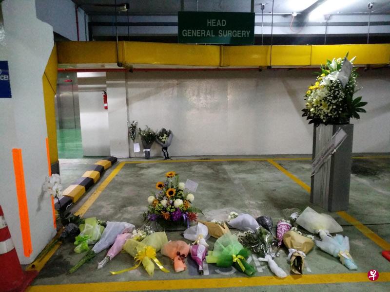 同事好友在医院停车场摆放花束以及花圈吊唁。