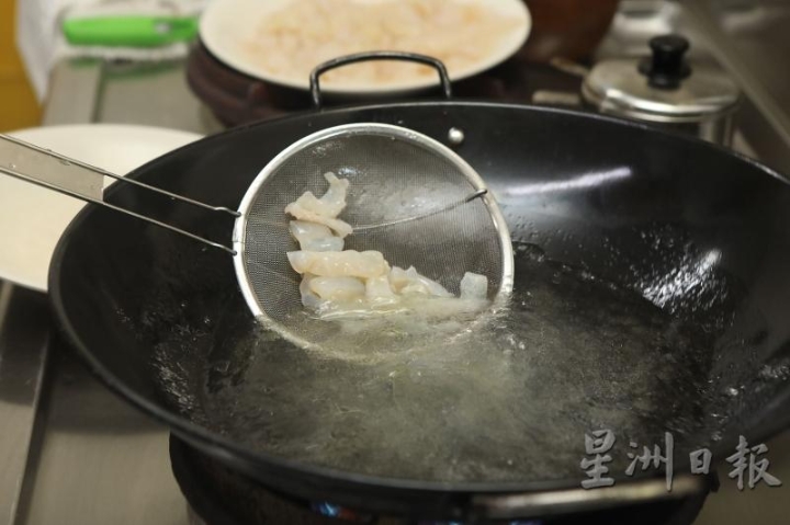 2. 锅中烧热水，加小量油和盐，搅拌均匀后放入水母焯水。捞起放凉，备用。