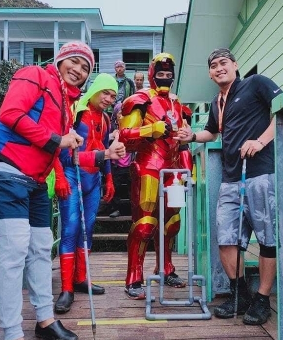 Iron Man aka Yahon Charles Jayasuriya (second from right) delivers the sanitizer dispenser made of PVC pipes by Francis Xavier Kinjin to the rest house at Laban Rata, which is near the peak of Mount Kinabalu.
