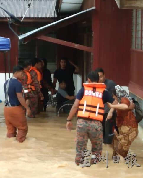 消拯人员协助所有灾黎离开淹水房屋。