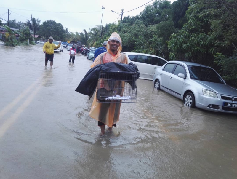 麻市今早降雨量达270毫米，创下历史新高。巫裔居民阿兹还来不及收拾细软，先把家中的宠物猫救出，准备安顿在马哈拉尼国中救灾中心。