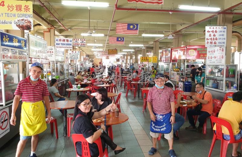 拉律峇登综合公市底层小贩中心恢复堂食了。右是李明辉；左是总务班亿来。