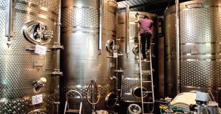 An employee climbing a wine tank at GranMonte Vineyard and Winery in Nakhon Ratchasima. AFP